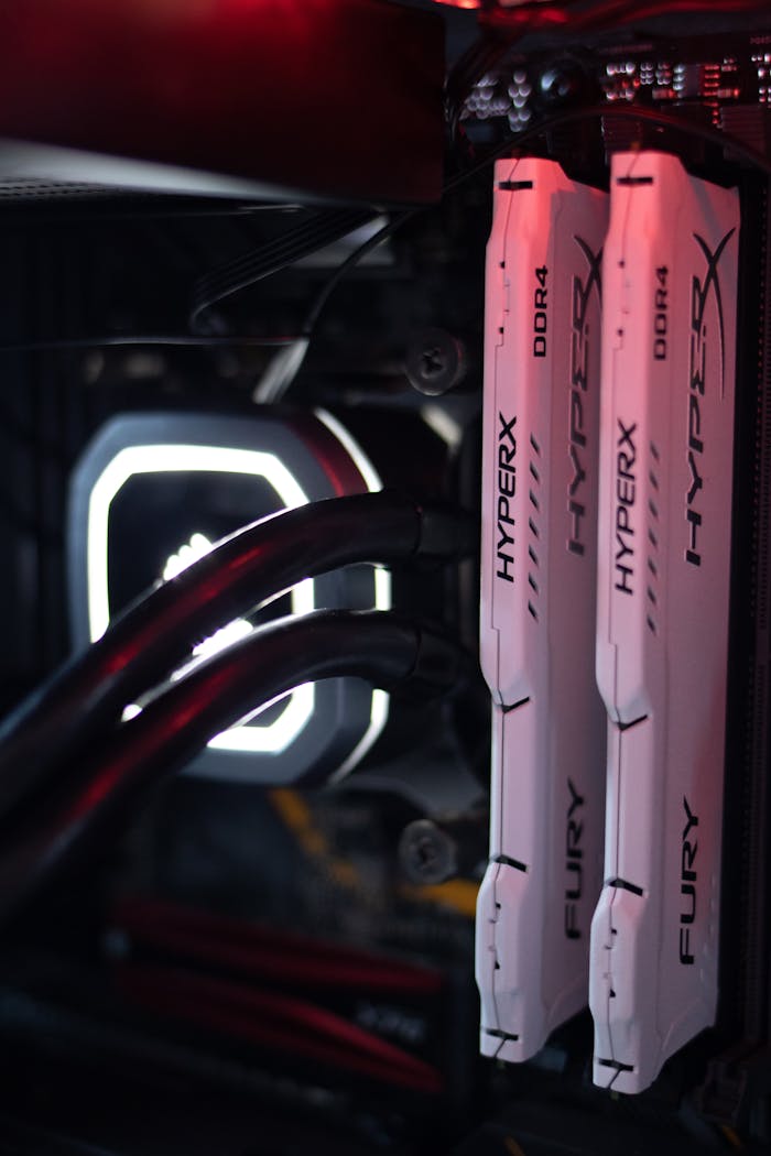 team-03 Detailed view of HyperX Fury DDR4 RAM in a gaming PC build with LED lighting.